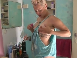 Hairy blonde plays with an electric toothbrush