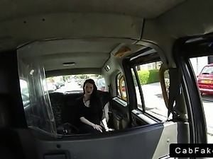 Dark haired babe in black dress banging in fake taxi