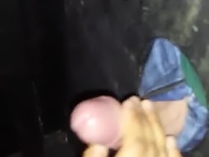 She finishes him with a handjob in the glory hole