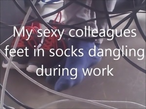 My sexy colleagues feet in socks dangling during work
