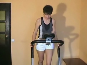 Lovely short haired brunette lady naked on the treadmill