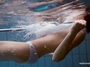 Flat chested chick Marusia exposes her pubic hair while swimming in the pool