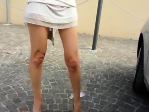 Seductive European babe exposes her sexy long legs outside 