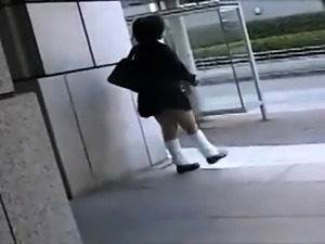 Naughty Japanese schoolgirl in uniform reveals her sweet ass