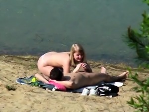 Beach voyeur spies on a young couple having passionate sex