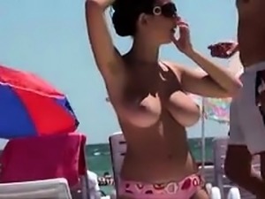 Gorgeous brunette flaunts her amazing big boobs on the beach