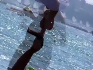 Beach voyeur finds a stunning brunette milf in a sexy bikini 