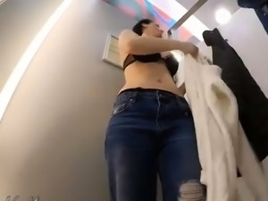 Busty babe plays with her hairy pussy in the changing room