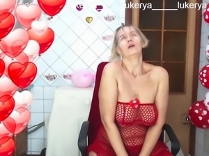 Sexy Lukerya in red between heart-shaped balloons for Valentines Day flirts...