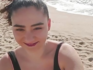 Brunette girl masturbates on public beach