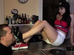 Sexy slim young dominatrix getting her lovely feet worshiped