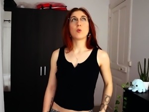 Provocative redhead in lingerie tries on new sex toys