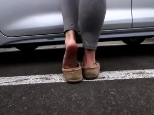 Hot brunette rubbing big black cock with her feet in the car